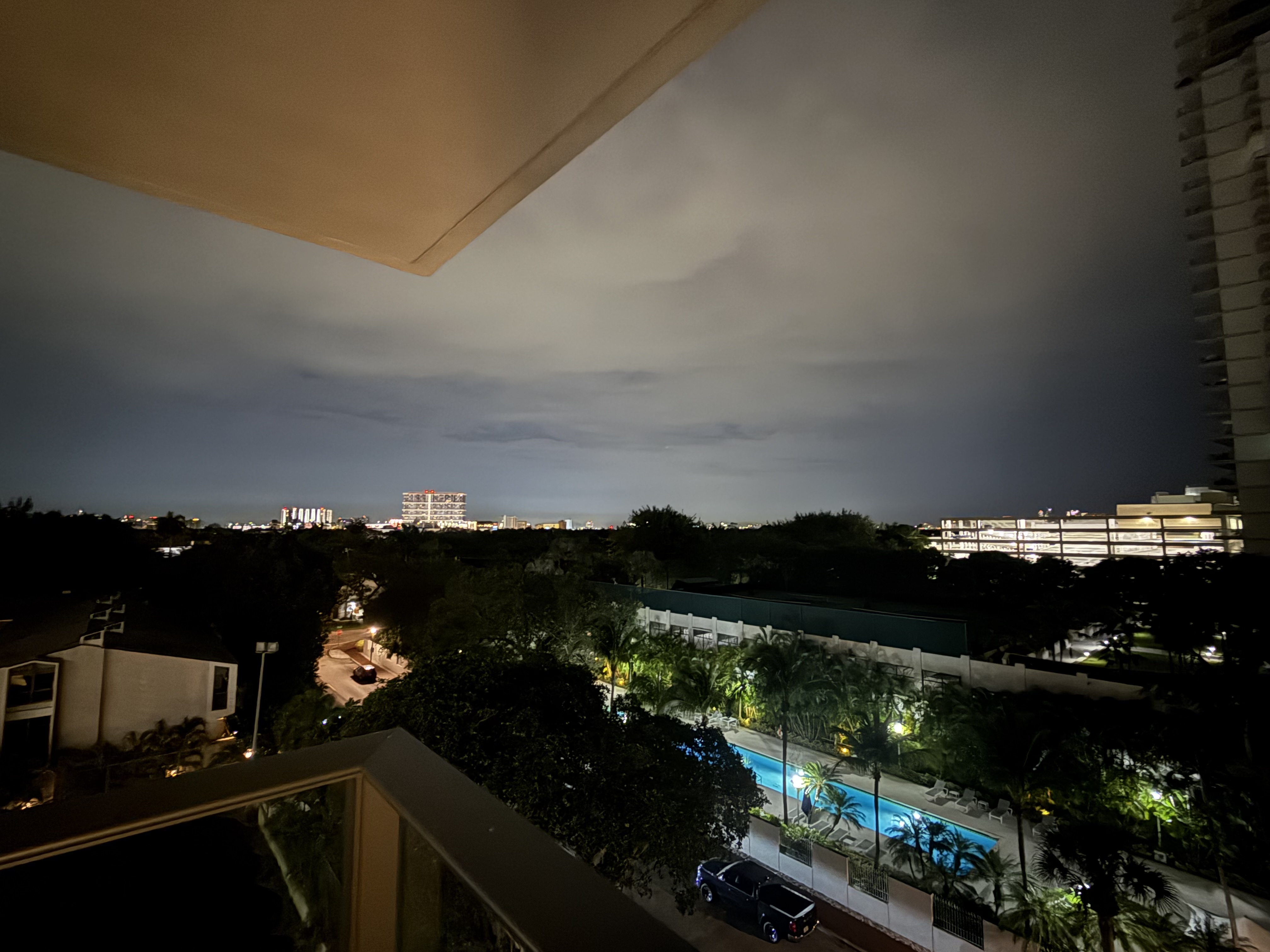 Evening view over the palms and pool from a hotel balcony at the metabolic health conference in Miami.